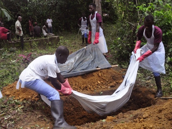 Ebola health care workers bury the body of a person suspected of dying from the Ebola, on the outskirts of Monrovia, Liberia, Saturday, Nov. 8, 2014. Dr. Robert Fuller didn't hesitate to go to Indonesia to treat survivors of the 2004 tsunami, to Haiti to help after the 2010 earthquake or to the Philippines after a devastating typhoon last year. But he's given up on going to West Africa to care for Ebola patients this winter. (AP Photo/ Abbas Dulleh)