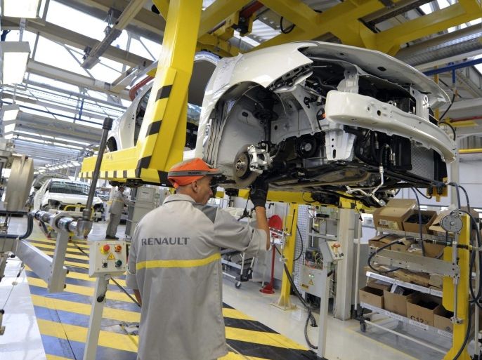 Employees work at the assembly line in the new Renault plant in Oran, western Algeria, Monday, Nov.10, 2014. The plant has been inaugurated Monday and is due to produce the Renault Symbol especially for the Algerian domestic market. The first new Renault car rolled off the assembly lines on Monday. (AP Photo/Sidali Djarboub)