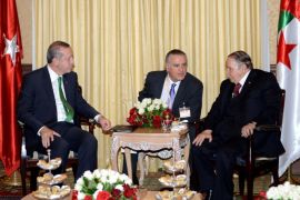 Turkish President Recep Tayyip Erdogan (L) meets with Algerian President Abdelaziz Bouteflika (R) following the former's arrival at Algiers airport, November 19, 2014, for an official visit to Algeria aimed at improving commercial ties. The trip is part of Ankara's efforts to shift its international focus to the Arab and Islamic world in light of the delay in its bid to join the European Union, the Algerian trade ministry said. AFP PHOTO / FAROUK BATICHE