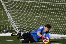 Real Madrid's goalkeeper Iker Casillas makes a save during their training session on the eve of their Spanish first division "Clasico" soccer match against Barcelona at Valdebebas training grounds in Madrid October 24, 2014. REUTERS/Susana Vera (SPAIN - Tags: SPORT SOCCER)