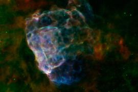 A handout picture made available by NASA on 24 August 2014 shows the destructive results of a mighty supernova explosion reveal themselves in a delicate blend of infrared and X-ray light, as seen in this image from NASAâs Spitzer Space Telescope and Chandra X-Ray Observatory, and the European Space Agency's XMM-Newton. The bubbly cloud is an irregular shock wave, generated by a supernova that would have been witnessed on Earth 3,700 years ago. The remnant itself, called Puppis A, is around 7,000 light-years away, and the shock wave is about 10 light-years across. The pastel hues in this image reveal that the infrared and X-ray structures trace each other closely. Warm dust particles are responsible for most of the infrared light wavelengths, assigned red and green colors in this view. Material heated by the supernovaâs shock wave emits X-rays, which are colored blue. Regions where the infrared and X-ray emissions blend together take on brighter, more pastel tones. The shock wave appears to light up as it slams into surrounding clouds of dust and gas that fill the interstellar space in this region. From the infrared glow, astronomers have found a total quantity of dust in the region equal to about a quarter of the mass of our sun. Data collected from Spitzerâs infrared spectrograph reveal how the shock wave is breaking apart the fragile dust grains that fill the surrounding space.Supernova explosions forge the heavy elements that can provide the raw material from which future generations of stars and planets will form. Studying how supernova remnants expand into the galaxy and interact with other material provides critical clues into our own origins.Infrared data from Spitzerâs multiband imaging photometer (MIPS) at wavelengths of 24 and 70 microns are rendered in green and red. X-ray data from XMM-Newton spanning an energy range of 0.3 to 8 keV (kiloelectron volts) are shown in blue. EPA/NASA/ESA/JPL-Caltech/GSFC/IAFE HANDOUT EDITORIAL USE