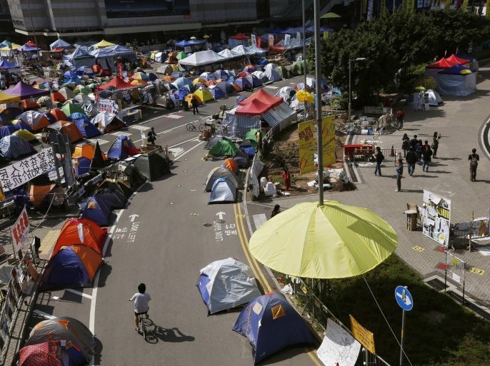 An installation in the shape of a yellow umbrella, a symbol of the Occupy Central civil disobedience movement, is seen at their Admiralty protest site in Hong Kong November 17, 2014. Police will take action this week to clear protesters from some occupied sites, according to South China Morning Post on Monday. Protesters have occupied key areas of Hong Kong for more than six weeks, camping out in some of the world's most expensive real estate and paralysing parts of the financial centre to demand free elections for the city's leader in 2017. REUTERS/Bobby Yip (CHINA - Tags: POLITICS BUSINESS EDUCATION CRIME LAW)