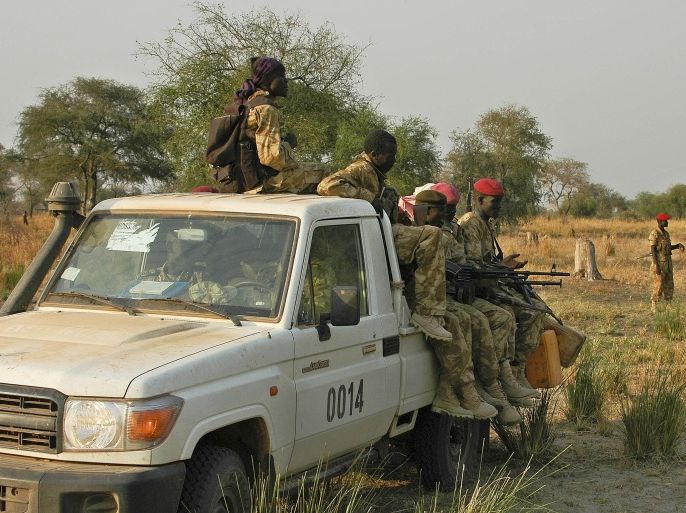 Government soldiers sit in a vehicle on January 18, 2014 in Bor, a strategic town they recaptured from rebel forces loyal to deposed vice president Riek Machar. South Sudanese government forces backed by Ugandan troops on Saturday recaptured the strategic town of Bor, defeating an army of thousands of rebels, officials said. Army spokesman Philip Aguer said soldiers entered the town, capital of Jonglei State and situated 200 kilometres (130 miles) north of the capital Juba, in the afternoon following days of fierce fighting. AFP PHOTO/Charles LOMODONG