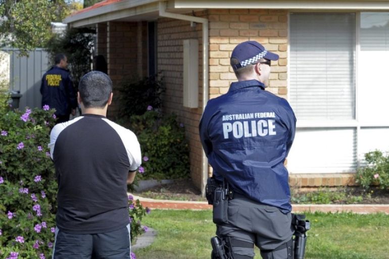 An Australian Federal Police (AFP) officer (R) stands alongside a member of the public at residential premises as part of anti-terrorism raids in Seabrook in Melbourne, Victoria, Australia, 30 September 2014. Police launched anti-terrorism raids across Melbourne on 30 September morning, taking one man into custody. Police said they raided premises in five suburbs with sniffer dogs while helicopters hovered overhead. Police confirmed that search warrants were being enacted as part of a counter-terrorism operation and it added in a statement that the actions were not in response to a threat to public safety. The action was not related to the Melbourne incident last week, where an 18-year-old terrorist suspect was shot dead by police after he attacked two officers with a knife. The raids follow a large operation last week where anti-terrorist police raided homes in Brisbane and Sydney. EPA/JULIAN SMITH AUSTRALIA AND NEW ZEALAND OUT
