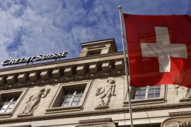 A national flag of Switzerland flies in front of a branch office of Swiss bank Credit Suisse in Luzern October 30, 2014. Credit Suisse said on Friday it added a net 390 million Swiss francs ($406 million) to its litigation provisions in the third quarter. Picture taken on October 30, 2014. REUTERS/Arnd Wiegmann (SWITZERLAND - Tags: BUSINESS LOGO)