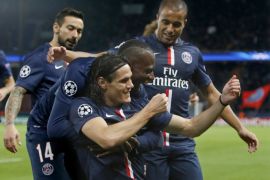 Paris St Germain's Edinson Cavani (bottom) reacts with teammates after scoring the first goal for his team during their Champions League soccer match against APOEL Nicosia at the Parc des Princes in Paris November 5, 2014. REUTERS/Charles Platiau (FRANCE - Tags: SPORT SOCCER)