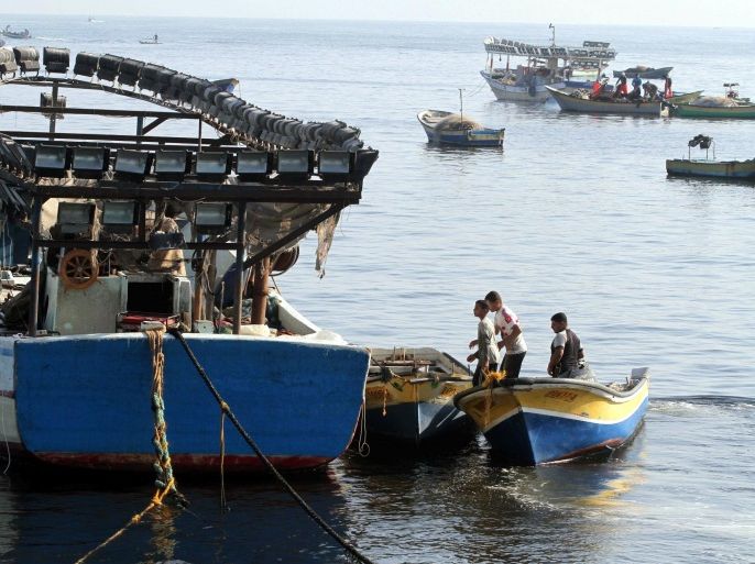 GAZA CITY, GAZA -AUGUST 7: Palestinian fishers ride a boat after they left from the seaport of Gaza City during the 72-hour humanitarian ceasefire in Gaza on August 7, 2014. Fishing provides significant employment area for Palestinians, in general fishers use fishing boat and nets while they hunting.