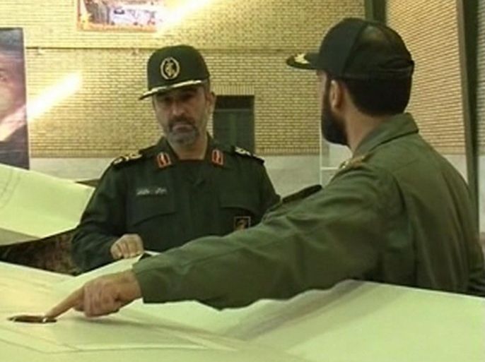 Islamic Revolutionary Guard Corps aerospace force commander Amir Ali Hajizadeh is briefed by a military officer (R) on what Iran says is a captured U.S. drone plane in an undisclosed location, in this still image taken from video footage broadcast by Iran's Al-Alam TV on February 6, 2013 and obtained by Reuters TV on February 7, 2013. Iran released what it said was the decoded footage taken by an unmanned U.S. RQ-170 reconnaissance drone plane that it captured more than a year ago, Iranian media reported. The grainy footage was broadcast on Iranian television late on Wednesday and showed images of what officials said were a U.S. base inside Afghanistan and several other aerial shots. Reuters was unable to confirm whether the footage was genuine but Iranian authorities have previously claimed to have decoded much of the data from the downed craft as well as valuable technology. REUTERS/Al-Alam TV via Reuters TV (IRAN - Tags: POLITICS MILITARY SCIENCE TECHNOLOGY) NO SALES. NO ARCHIVES. ATTENTION EDITORS - THIS PICTURE WAS PROVIDED BY A THIRD PARTY. REUTERS IS UNABLE TO INDEPENDENTLY VERIFY THE AUTHENTICITY, CONTENT, LOCATION OR DATE OF THIS IMAGE. FOR EDITORIAL USE ONLY. NOT FOR SALE FOR MARKETING OR ADVERTISING CAMPAIGNS. THIS PICTURE IS DISTRIBUTED EXACTLY AS RECEIVED BY REUTERS, AS A SERVICE TO CLIENTS. IRAN OUT. NO COMMERCIAL OR EDITORIAL SALES IN IRAN. NO ACCESS BBC PERSIAN TV / VOA PERSIAN NEWS NETWORK