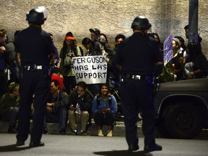 A group of protesters are blocked in by Los Angeles police officers as hundreds of demonstrators marched in Los Angeles, California, USA, 28 November 2014. Demonstrators were detained and issued with a warning and then released. A few hundred protestors demonstrated after a controversial verdict in the police shooting case in Ferguson, Missouri.