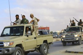 Forces loyal to former general Khalifa Haftar ride in vehicles in Benghazi November 20, 2014. Libya is in growing chaos as armed factions compete for power. One has taken over the capital Tripoli, setting up its own government and parliament and forcing the elected parliament and administration of Prime Minister Abdullah al-Thinni to move east. Picture taken November 20, 2014. REUTERS/Stringer (LIBYA - Tags: CIVIL UNREST POLITICS CONFLICT)