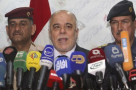 Iraqi Prime Minister Haider al-Abadi (C) speaks at a news conference in Kerbala, southwest of Baghdad, December 8, 2014. REUTERS/Mushtaq Muhammed (IRAQ - Tags: POLITICS)