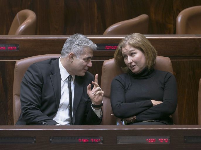 Israel's dismissed Finance Minister Yair Lapid and Justice Minister Tzipi Livni talk after a vote to dissolve parliament of the Knesset, the Israeli parliament, in Jerusalem December 3, 2014. Israeli legislators agreed in a preliminary vote on Wednesday to dissolve parliament, and they set March 17 as the date for a new parliamentary election after Prime Minister Benjamin Netanyahu fired two centrist cabinet members and declared an early national ballot. According to opinion polls, Netanyahu, whose current government took office only two years ago, is on course to win a fourth term as prime minister. REUTERS/Baz Ratner (JERUSALEM - Tags: POLITICS)