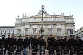 Carabinieri police keep guard in front of La Scala opera house on the first day of opera season in downtown Milan December 7, 2014. "Fidelio" of Ludwig van Beethoven, directed by Daniel Barenboim, will open for the 2014 opera season at opera house. As with previous years, demonstrations would take place on opening night as a way of highlighting protesters' demands and various issues in the country. REUTERS/Alessandro Garofalo (ITALY - Tags: CIVIL UNREST)