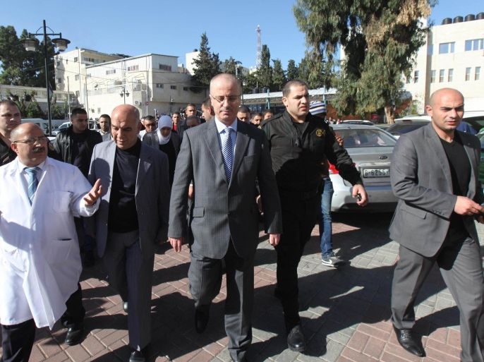 RAMALLAH, WEST BANK - DECEMBER 10: Palestinian Prime Minister Rami Hamdallah (C) visits the hospital where Ziad Abu Ein, cabinet member in charge of the settlements file at the Palestine Liberation Organization (PLO), was taken to after fainting following the intervention of Israeli security forces during a demonstration in Ramallah, West Bank on December 10, 2014. Ziad Abu Ein is reported dead Wednesday after allegedly inhaling tear gas used by Israeli police to disperse a demonstration against the Israeli occupation.