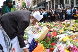 A Muslim man and a relative join thousands of Sydneysiders in laying flowers near the Lindt chocolate cafe in Martin Place following last nights dramatic siege in Sydney, Australia, 16 December 2014. Police stormed a central Sydney cafe after a fringe Islamist with a criminal record allegedly held customers and staff hostage at gunpoint for more than 16 hours. The suspected gunman, who came to Australia as a refugee from Iran in 1996, was killed as well as two hostages. EPA/DEAN LEWINS AUSTRALIA AND NEW ZEALAND OUT