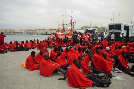 (FILES) A file picture taken on August 11, 2014 shows would-be immigrants resting at Tarifa's harbour after being rescued off the Spanish Coast. Three babies were among nine illegal migrants who died on December 19, 2014 after their inflatable vessel capsized off the coast of Morocco, local police said. AFP PHOTO / MARCOS MORENO