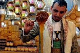 epa03545115 A Yemeni vendor displays honey for sale in a shop in Sana'a, Yemen, 19 January 2013. Government figures suggest Yemen's honey production is estimated at 5,000 tons a year with revenues of more than 80 million US dollars. The number of bee communities exceeds 1.2 million. EPA/YAHYA ARHAB