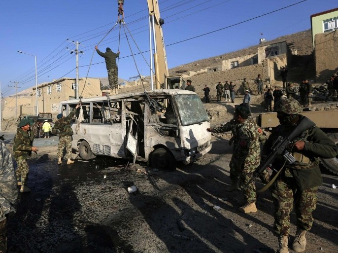 Afghan National Army soldiers (ANA) inspect the site of a suicide attack in Kabul December 11, 2014. A suicide bomber targeted a bus carrying Afghan army personnel, killing six soldiers and wounding 11 on Thursday on the outskirts of the capital, Kabul, the Defence Ministry said. REUTERS/Omar Sobhani (AFGHANISTAN - Tags: CIVIL UNREST)