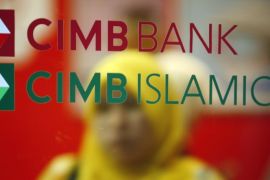 A customer leaves a branch of Malaysia's CIMB Bank in Kuala Lumpur in this November 16, 2009 file photo. As Islamic finance expands 15-20 percent a year and enters new markets from Australia to South Africa, so the need has grown for more sharia advisers who can structure financial transactions according to Islamic rules that crucially include a ban on interest. The number of women sharia scholars in Malaysia has more than tripled in the last five years according to some estimates.