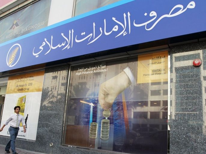 A man walks past an Emirates Islamic Bank branch in Bank street in Dubai, in this October 18, 2011 file photo. As it recovers from a crippling property market crash in 2009-2010, the emirate has set its sights on becoming a global centre for Islamic business - activity conducted under religious principles, in areas from banking and insurance to food production, education, tourism and contract negotiation. To match ISLAMIC-FINANCE/DUBAI REUTERS/Jumana El Heloueh/Files (UNITED ARAB EMIRATES - Tags: BUSINESS)