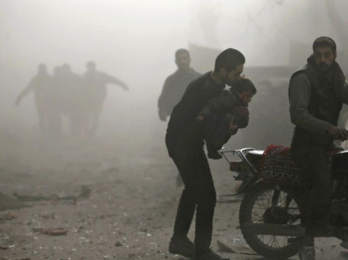 A man carries an injured child to a motorcycle at a site hit by what activists said was an air strike by forces of Syria's President Bashar al-Assad in the Duma neighbourhood of Damascus December 27, 2014. REUTERS/Bassam Khabieh (SYRIA - Tags: CIVIL UNREST CONFLICT)