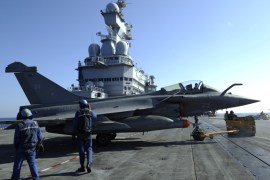 French Marines prepare a Rafale jet fighter on the deck of the French aircraft carrier Charles De Gaulle on March 25, 2011 during the 'Odyssey Dawn' operations in Libya. French President said on March 25, 2011 France and Britain were readying a 'political and diplomatic' solution on Libya.
