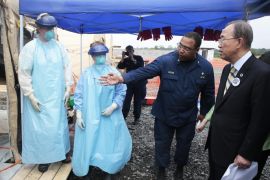 A handout picture made available by the United Nations (UN) shows UN Secretary-General Ban Ki-moon (R) taking a tour of a US medical facility in Monrovia, Liberia, 19 December 2014. Ban is on a trip to several West African countries affected by Ebola. EPA/UN PHOTO/EVAN SCHNEIDER