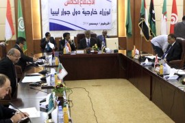 Sudanese Foreign Minister Ali Ahmed Karti (C) chairs a meeting of high-level representatives from countries neighbouring Libya aimed at finding a solution to the conflict in the North African country, on December 4, 2014 in Khartoum. AFP PHOTO/ASHRAF SHAZLY