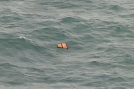 This aerial view taken from an Indonesian search and rescue aircraft over the Java Sea shows floating debris spotted in the same area as other items being investigated by Indonesian authorities as possible objects from missing AirAsia flight QZ8501 on December 30, 2014. Items resembling an emergency slide, plane door and other objects were spotted during a aerial search on December 30 for the missing AirAsia plane, according to information from the flight on which AFP was aboard.    AFP PHOTO / Bay ISMOYO