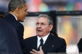 U.S. President Barack Obama (L) greets Cuba's President Raul Castro (C) before giving his speech, as Brazil's President Dilma Rousseff looks on, at the memorial service for late South African President Nelson Mandela in Johannesburg in this December 10, 2013 file photo. The United States and Cuba agreed on December 17, 2014 to restore diplomatic ties that Washington severed more than 50 years ago, and Obama called for an end to the long economic embargo against its old Cold War enemy. After 18 months of secret talks, Obama and Castro agreed in a phone call on December 16 on a breakthrough prisoner exchange, the opening of embassies in each other's countries, and an easing of some restrictions on commerce. REUTERS/Kai Pfaffenbach/files (SOUTH AFRICA - Tags: POLITICS)