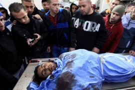 RAMALLAH, WEST BANK - DECEMBER 16: The dead body of Palestinian Mahmoud Adwan shot in the head during clashes with Israeli forces in the Qalandia refugee camp near the West Bank city of Ramallah on Tuesday, is carried to Palestine Medical Complex (PMC) in Ramallah on December 16,2014.
