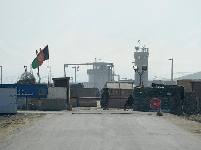 Afghan National Army (ANA) soldiers stand guard at the Bagram prison gate, some 50 kms north of Kabul on Fabruary 13, 2014. Afghanistan released 65 alleged Taliban fighters from jail despite condemnation from the United States, which says the men could return to the battlefield to launch strikes against NATO and Afghan forces. The release of detainees from Bagram prison is set to worsen the increasingly-bitter relationship between Kabul and Washington as US-led troops prepare to withdraw after 13 years fighting the Islamist militants. AFP PHOTO/SHAH Marai