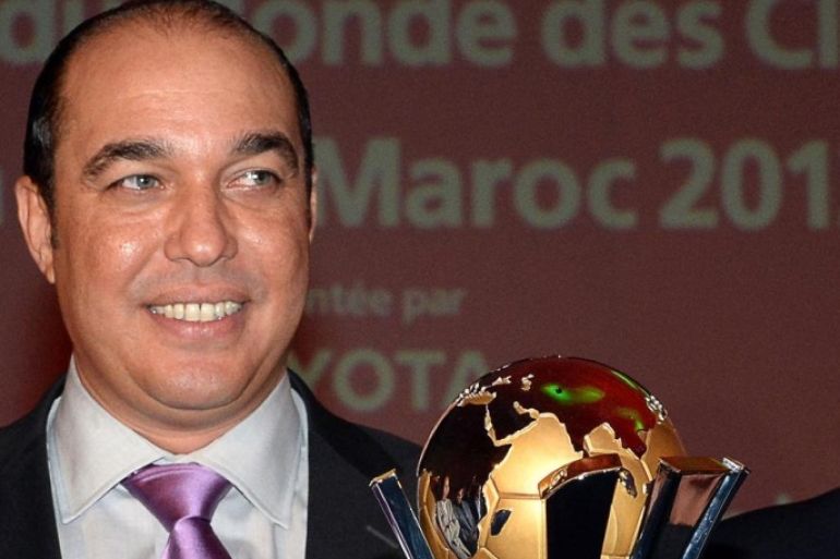Morocco's Minister of Youth and Sports Mohammed Ouzzine (L) and Royal Moroccan Football Federation (FRMF) President Ali Fassi Fihri (R) pose behind the FIFA Club World Cup 2013 trophy during its presentation as part of a press conference on September 2, 2013 in Casablanca. Morocco will become the first African country to host the annual Club World Cup of continental winners, scheduled to be played from 11 to 21 December 2013.