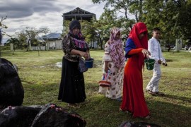 BANDA ACEH, INDONESIA - DECEMBER 26: An Acehnese family pours water as they pray at mass grave to commemorate the tenth anniversary of the Boxing Day tsunami on December 26, 2014 in Banda Aceh, Indonesia. Aceh was the worst hit location, being the closest major city to the epicentre of the 9.1 magnitude quake, suffering a huge hit from the following tsunami and resulting in around 130,000 deaths. Throughout the affected region of eleven countries, nearly 230,000 people were killed, making it one of the deadliest natural disasters in recorded history.