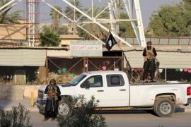 BAIJI, IRAQ - JULY 30: During the Eid al-Fitr, Islamic State of Iraq and Levant-led militants patrol on the roads of Baiji after they control the city in Iraq on July 30, 2014.