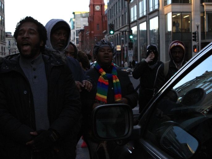 WASHINGTON, DC - DECEMBER 07: Dozens of protesters march throughout downtown and stop the the traffic at major intersections in Washington, United States on December 7, 2014 to protest the killings of unarmed black men by police officers.