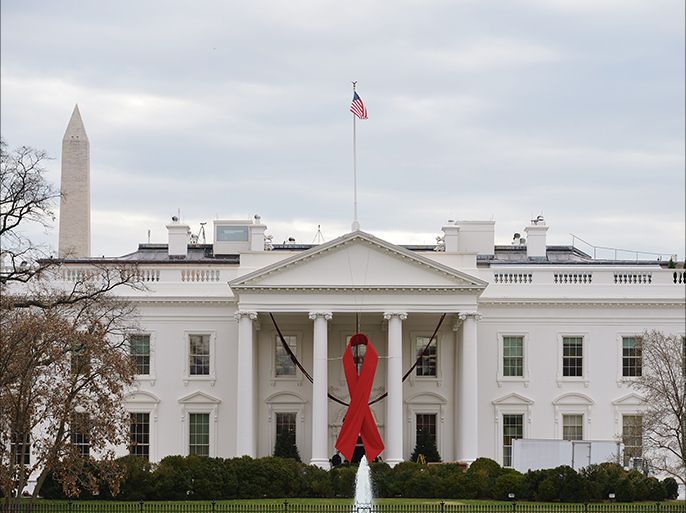 A giant red ribbon is affixed on the front of the White House on World Aids Day, on December 1, 2014 in Washington, DC. AFP PHOTO/Mandel NGAN