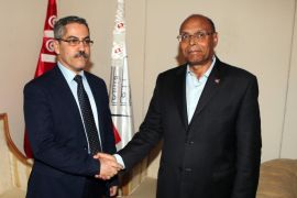Tunisian presidential candidate Moncef Marzouki (R) shakes hands with head of the Tunisian ISIE election commission Chafik Sarsar (L) in Tunis, Tunisia, 01 December 2014. Tunisian former prime minister Beji Caid Essibsi will face incumbent Moncef Marzouki in a run-off vote for the presidency in December.