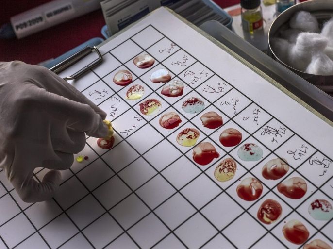 A health official puts blood samples on a blood type grouping test chart during World Blood Donor Day 2014 in Kuala Lumpur, Malaysia, 14 June 2014. Only 2.5 percent of the Malaysian population are regular blood donors compared to five to ten percent in other countries in the world.