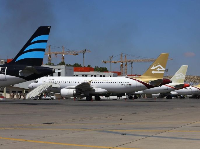 A picture made available on 19 July 2014 shows planes and smoke rising following clashes between rival militias at the main airport of Tripoli, Libya, 16 July 2014. Clashes erupted between rival militias in the Libyan capital Tripoli on 18 July 2014 hours after they had reached a truce deal. The fighting erupted around the main airport in the capital, Dubai-based broadcaster Al-Arabiya said. No casualties were reported. An Islamist militia from the town of Misrata, 200 km west of Tripoli, has been engaged since 13 July in fighting against an armed group from the north-western town of Zintan, which has controlled the airport since the overthrow of Gaddafi in 2011.