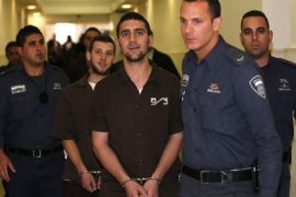Israeli prison guards escort far-right activists at Jerusalem District Court December 15, 2014. The Three Israelis from a far-right group Lehava, which objects to personal or business relations between Jews and Arabs, were charged on Monday with setting fire to a classroom in an Arab-Jewish school that has been a symbol of co-existence in Jerusalem. REUTERS/Ammar Awad (JERUSALEM - Tags: POLITICS CRIME LAW)