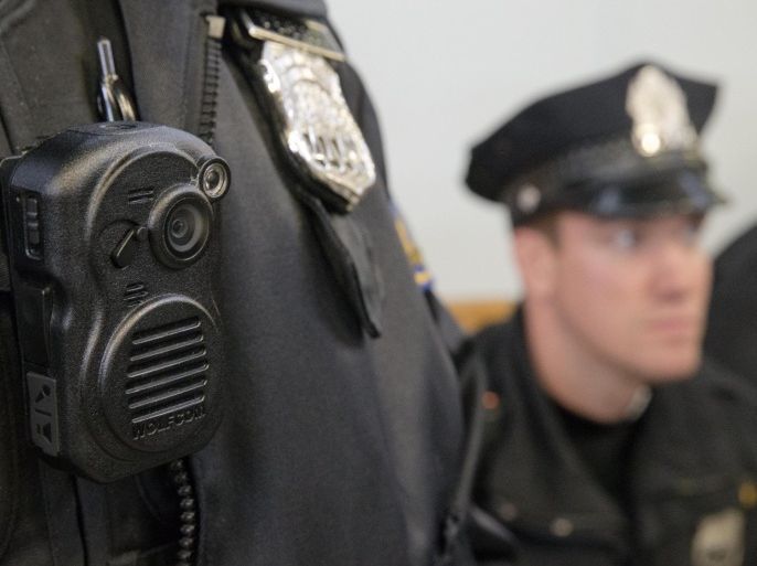 Philadelphia Police officers demonstrate a body-worn cameras being used as part of a pilot project in the department's 22nd District, Thursday, Dec. 11, 2014, in Philadelphia. (AP Photo/Matt Rourke)