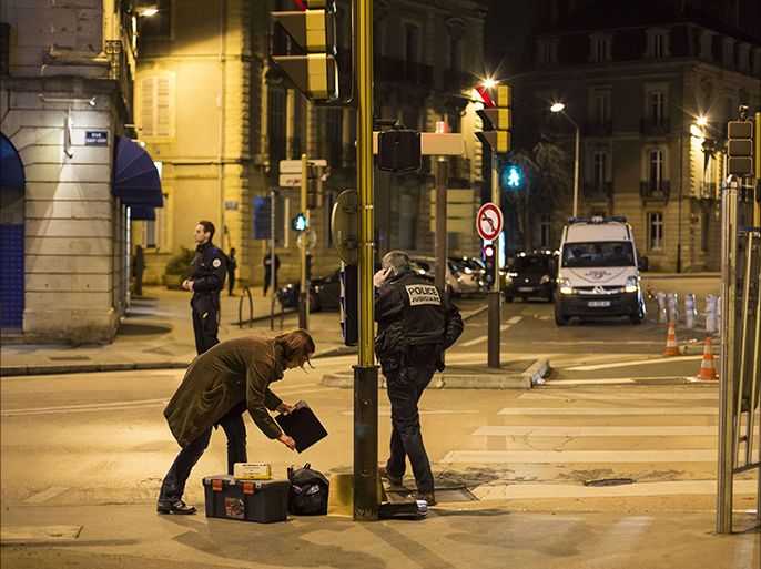 Policemen collect evidence on December 21, 2014 in Dijon on the site where a driver shouting "Allahu Akbar" ("God is great") ploughed into a crowd injuring 11 people, two seriously, a source close to the investigation said. Two of the people injured in the car attack in the city of Dijon were in a serious condition, a police source said, adding that the driver had been arrested. AFP