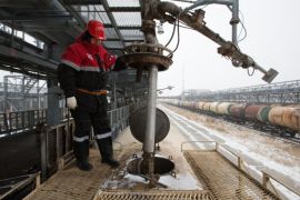 A worker overseas the loading of oil supplies into freight wagons at the Lukoil-Nizhegorodnefteorgsintez oil refinery, operated by OAO Lukoil, in Nizhny Novgorod, Russia, on Thursday, Dec. 4, 2014. Crude slumped 18 percent last month as the Organization of Petroleum Exporting Countries maintained its output quota, letting prices decrease to a level that may slow U.S. production.