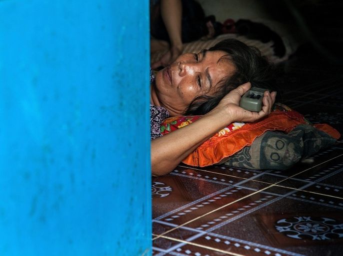 TUOL SAMBO, CAMBODIA - SEPTEMBER 06: A HIV-positive woman lays on the floor of her house in the Tuol Sambo community on September 6, 2014 in Tuol Sambo, Cambodia. Three different communities live on the outskirts of Phnom Penh in the village of Tuol Sambo, called the 'AIDS colony' by locals as close to 50 families living there are HIV-positive. Since almost all health organisations ceased operating in Tuol Sambo several months ago, the community is entirely dependent on one clinic which provides HIV medication free of charge once a week. This isolated community, of which 10% are children who were born with HIV, struggles from a lack of access to income, proper nutrition and other essential services. Despite these challenges, new HIV-positive families have recently arrived to Tuol Sambo seeking a place where discrimination is not part of their daily life. There are approximately 75,000 people living with HIV in Cambodia.