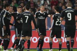 Real Madrid's Gareth Bale from Wales, second left, is surrounded by teammates to celebrate his goal during a Spanish La Liga soccer match at the Juegos Mediterraneos stadium in Almeria, southeast Spain, Friday, Dec. 12, 2014. (AP Photo/Daniel Tejedor)