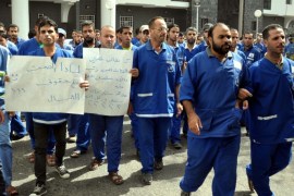 GAZA CITY, GAZA - SEPTEMBER 24: Hospital cleaning workers who stage a three-day-strike all around Gaza Strip to demand their five months of overdue salaries from the Palestinian Health Ministry protest at Al-Shifa Hospital of Gaza City, Gaza on September 24, 2014.