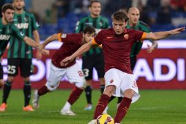 Roma's forward from Serbia Adem Ljajic kicks and score during the Italian Serie A football match As Roma vs Sassuolo on December 6 2014 at the Olympic stadium in Rome. AFP PHOTO / ALBERTO PIZZOLI