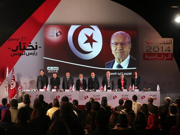 Head of the Tunisian ISIE election commission Chafik Sarsar (4-L) along with other members of the commission give a press conference to announce the final results of the presidential elections, in Tunis, Tunisia, 29 December 2014. The Tunisian Independent High Authority for Elections (ISIE) announced on 22 December that veteran politician Beji Caid Essibsi has won Tunisia's first free presidential elections with 55.68 per cent of the vote. The commission said his rival, outgoing President Moncef Marzouki, had received 44.32 per cent of the ballots. A swearing-in ceremony for Essebsi is scheduled for 31 December.