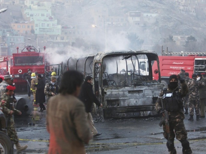 Afghan security guards inspect a damaged bus at the site of a suicide attack by the Taliban in Kabul, Afghanistan, Saturday, Dec. 13, 2014. A senior Afghan defense official said that the suicide bomber struck the Defense Ministry bus carrying Afghan Army personnel, killing several as violence in the country spikes just weeks before most international combat forces withdraw. (AP Photo/Rahmat Gul)